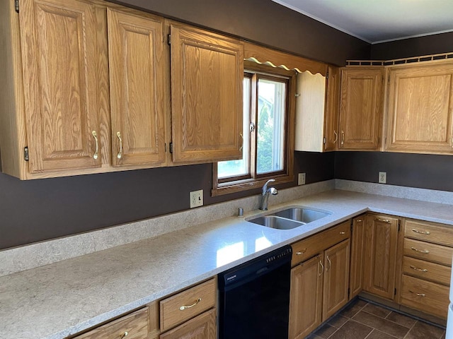 kitchen with black dishwasher, a sink, light countertops, dark tile patterned flooring, and crown molding