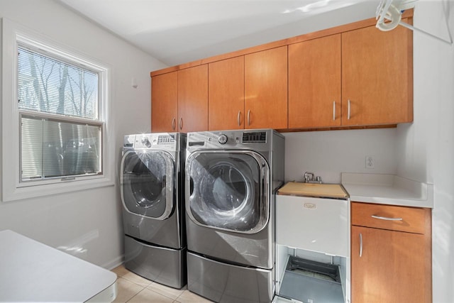 7515 N Beach Dr, Fox Point, WI 53217 - clothes washing area with cabinet space, washing machine and clothes dryer, and light tile patterned floors
