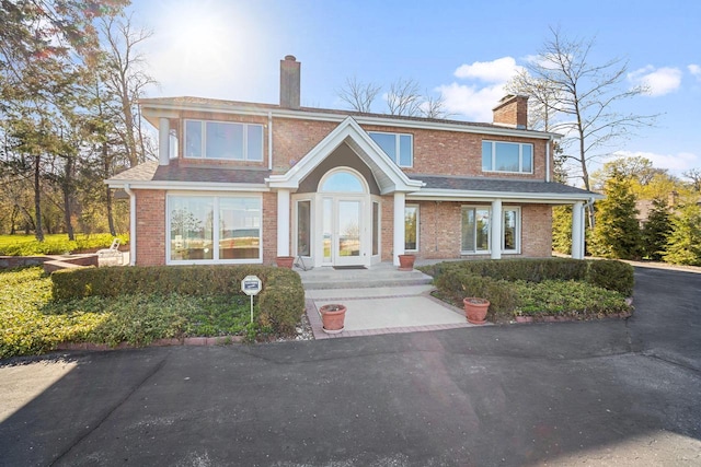 7515 N Beach Dr, Fox Point, WI 53217 - traditional home with a chimney and brick siding