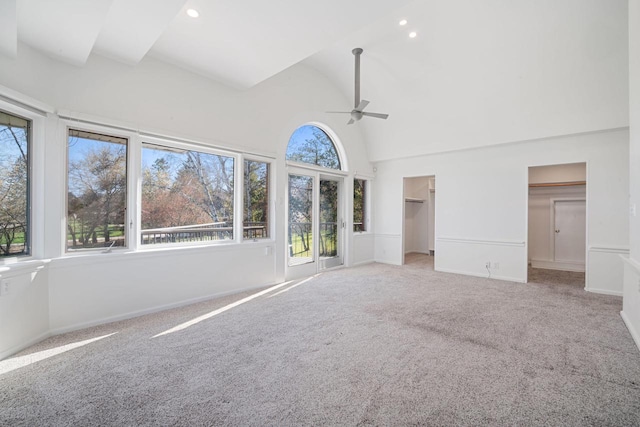 7515 N Beach Dr, Fox Point, WI 53217 - unfurnished living room featuring ceiling fan, carpet floors, a towering ceiling, baseboards, and recessed lighting