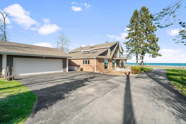 7515 N Beach Dr, Fox Point, WI 53217 - multi unit property featuring a balcony, brick siding, and a water view