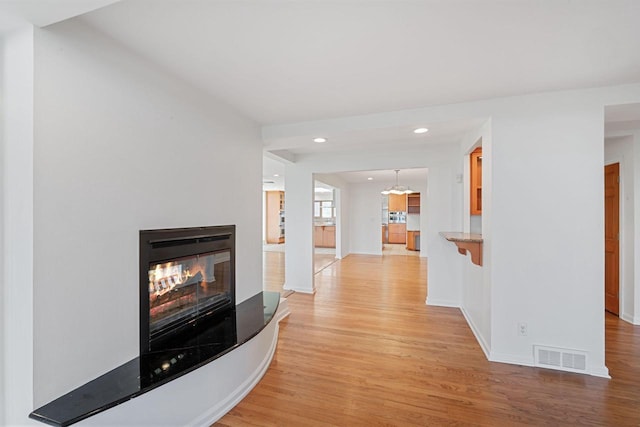7515 N Beach Dr, Fox Point, WI 53217 - hallway with light wood-type flooring, baseboards, and recessed lighting