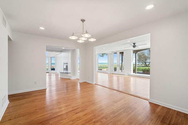 7515 N Beach Dr, Fox Point, WI 53217 - unfurnished dining area featuring light wood-style flooring, plenty of natural light, baseboards, and recessed lighting