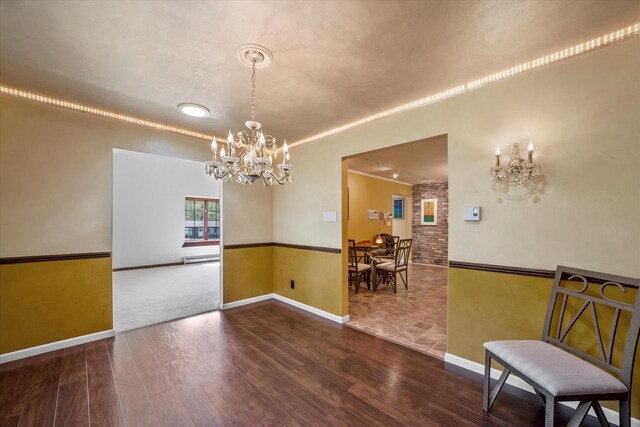 1401 Scenic Dr, Hubertus, WI 53033 - dining room featuring a chandelier, wood finished floors, and baseboards