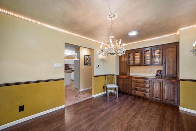 1401 Scenic Dr, Hubertus, WI 53033 - dining area with a chandelier, dark wood finished floors, and baseboards