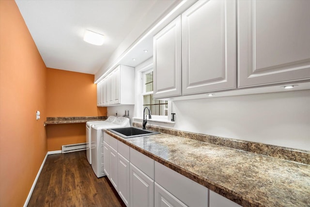 1401 Scenic Dr, Hubertus, WI 53033 - washroom featuring cabinet space, washer and clothes dryer, dark wood-style flooring, baseboards, and a baseboard radiator