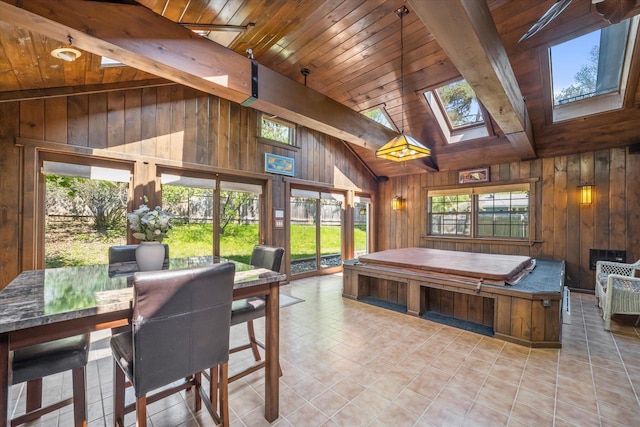 1401 Scenic Dr, Hubertus, WI 53033 - dining area with wooden walls, wood ceiling, a skylight, beamed ceiling, and tile patterned floors