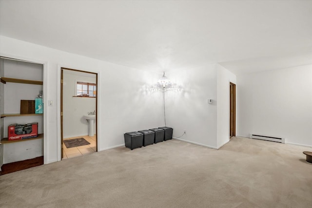 1401 Scenic Dr, Hubertus, WI 53033 - unfurnished living room featuring a baseboard heating unit, carpet flooring, a chandelier, and baseboards