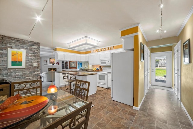 1401 Scenic Dr, Hubertus, WI 53033 - dining space featuring rail lighting, baseboards, dark stone finish flooring, and crown molding