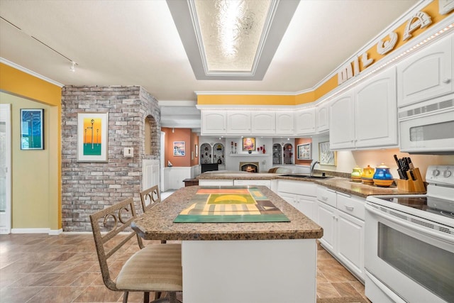 1401 Scenic Dr, Hubertus, WI 53033 - kitchen with white appliances, a sink, a kitchen breakfast bar, a center island, and white cabinetry