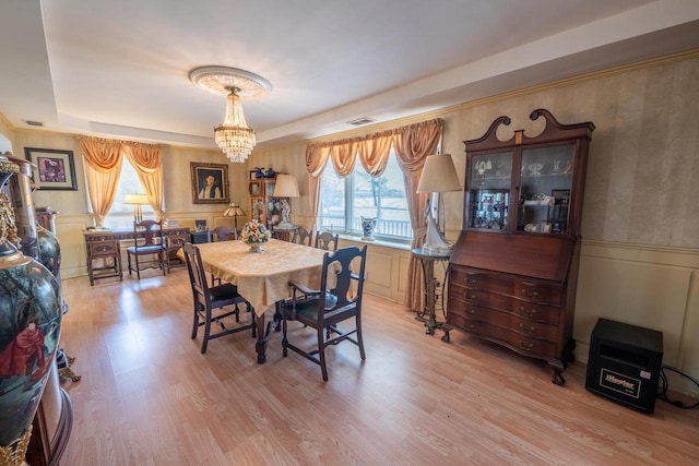 1226 Lake St, White Lake, WI 54491 - dining area with wainscoting, plenty of natural light, light wood-style flooring, a chandelier, and a tray ceiling