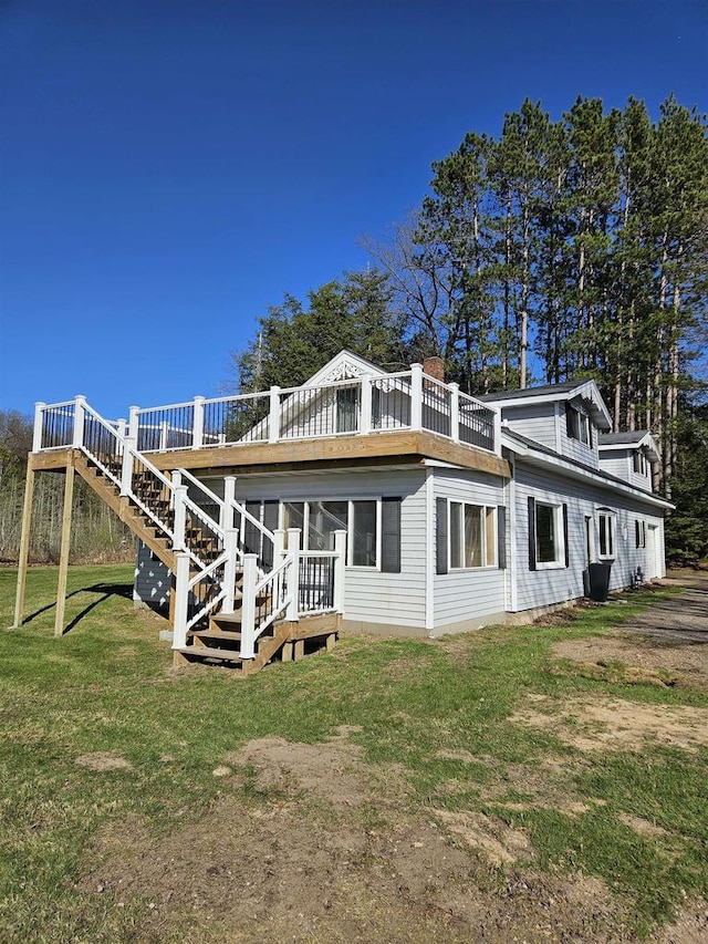 1226 Lake St, White Lake, WI 54491 - rear view of property featuring stairway, a deck, a lawn, and a sunroom