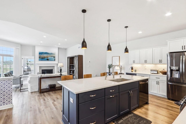 W139S9977 Jay Dr, Muskego, WI 53150 - kitchen featuring stainless steel fridge with ice dispenser, a sink, white cabinets, dishwasher, and light countertops
