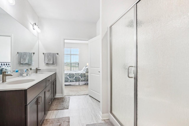 W139S9977 Jay Dr, Muskego, WI 53150 - full bathroom featuring ensuite bath, a stall shower, double vanity, and baseboards