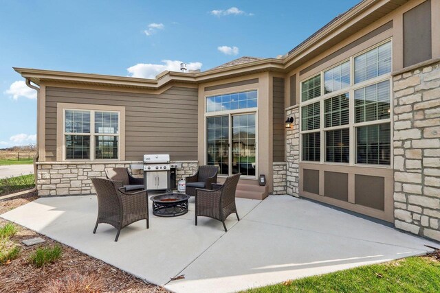 W139S9977 Jay Dr, Muskego, WI 53150 - view of patio featuring a fire pit and a grill