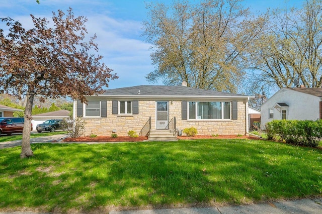 1201 Redwood Dr, Green Bay, WI 54304 - view of front of home featuring stone siding, a front yard, and entry steps