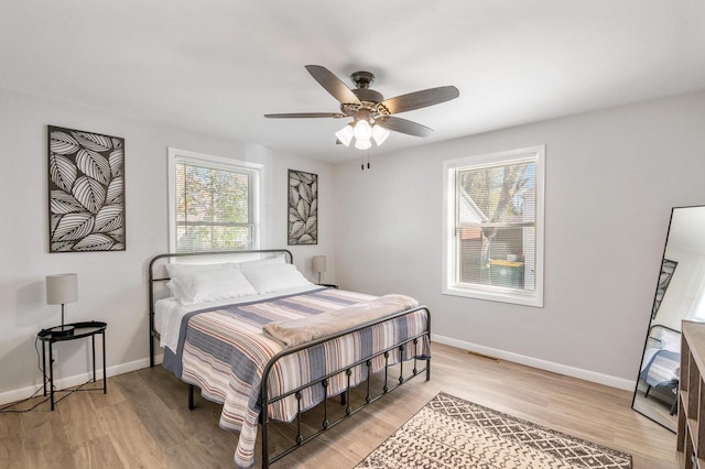 1201 Redwood Dr, Green Bay, WI 54304 - bedroom with baseboards, light wood-style flooring, and a ceiling fan