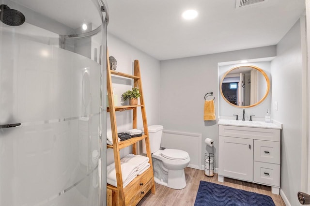 1201 Redwood Dr, Green Bay, WI 54304 - bathroom featuring wood finished floors, toilet, a shower, vanity, and baseboards