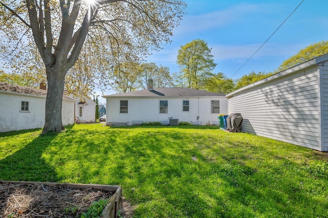 1201 Redwood Dr, Green Bay, WI 54304 - rear view of property with a lawn and central AC unit
