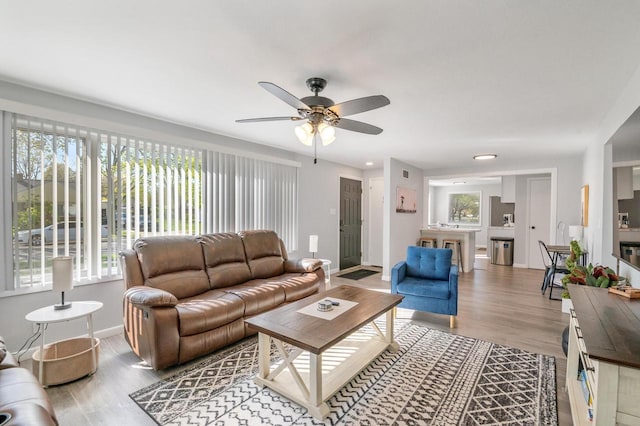 1201 Redwood Dr, Green Bay, WI 54304 - living area with plenty of natural light, a ceiling fan, and wood finished floors