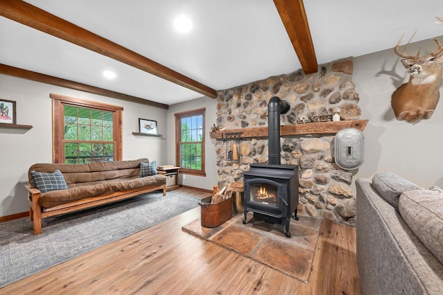 5458 Cascade Dr, West Bend, WI 53095 - living room with beamed ceiling, wood finished floors, a wood stove, baseboards, and recessed lighting