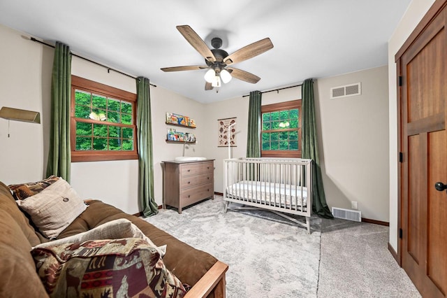 5458 Cascade Dr, West Bend, WI 53095 - carpeted bedroom with multiple windows, ceiling fan, and baseboards