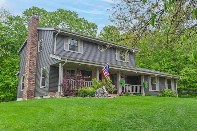 5458 Cascade Dr, West Bend, WI 53095 - view of front of home with covered porch, a chimney, and a front lawn