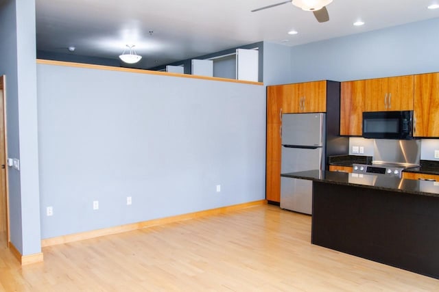 615 W Main St Unit 205, Madison, WI 53703 - kitchen featuring black microwave, freestanding refrigerator, brown cabinets, light wood-style flooring, and recessed lighting