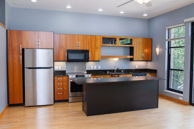 615 W Main St Unit 205, Madison, WI 53703 - kitchen featuring appliances with stainless steel finishes, a sink, light wood-style floors, a center island, and recessed lighting