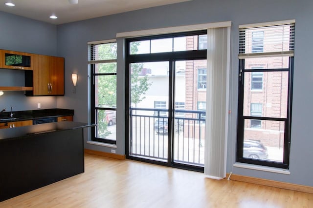 615 W Main St Unit 205, Madison, WI 53703 - kitchen featuring a sink, light wood finished floors, dark countertops, plenty of natural light, and recessed lighting