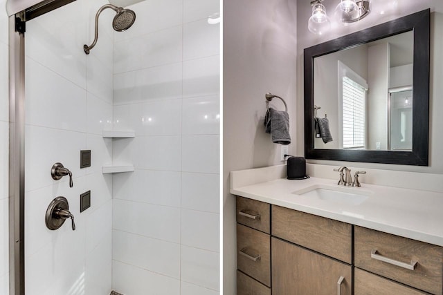 bathroom with tiled shower and vanity