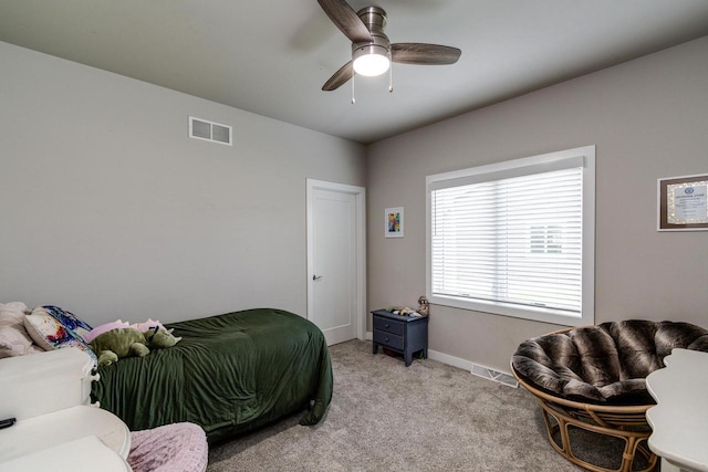 bedroom with light colored carpet, baseboards, and ceiling fan