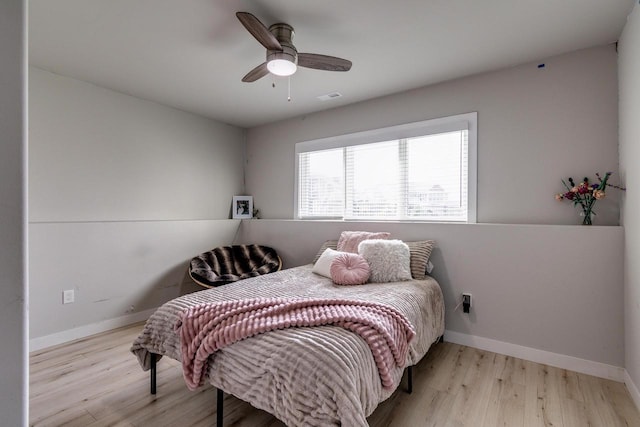 bedroom featuring wood finished floors, baseboards, and ceiling fan
