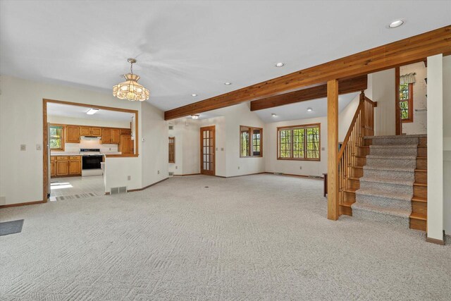 5287 Pleasant Hill Rd, Hartford, WI 53027 - unfurnished living room featuring recessed lighting, baseboards, light colored carpet, a chandelier, and stairs