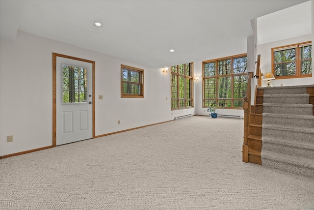 5287 Pleasant Hill Rd, Hartford, WI 53027 - unfurnished living room featuring carpet flooring, stairs, a baseboard heating unit, baseboards, and recessed lighting