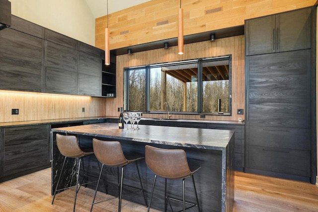 W4310 33rd St, Necedah, WI 54646 - bar featuring light wood-style floors, a sink, lofted ceiling, and wooden walls