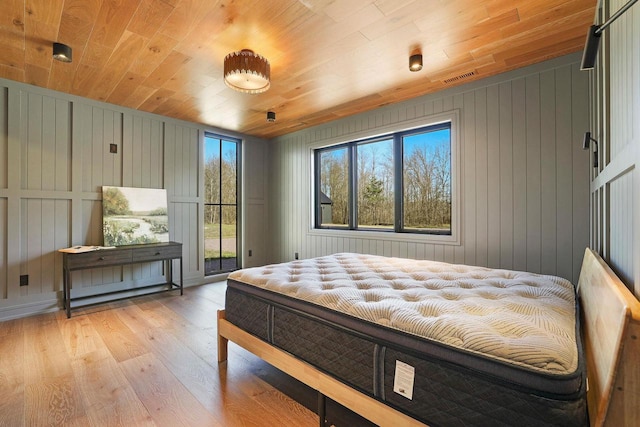 W4310 33rd St, Necedah, WI 54646 - bedroom featuring wood ceiling, light wood finished floors, access to outside, and wooden walls