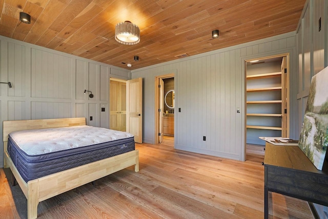 W4310 33rd St, Necedah, WI 54646 - bedroom with light wood finished floors, wood ceiling, baseboards, and wooden walls