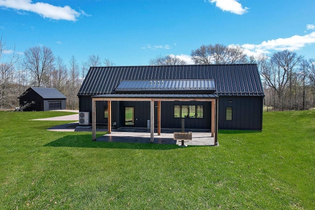 W4310 33rd St, Necedah, WI 54646 - back of property with a patio, a yard, metal roof, and board and batten siding