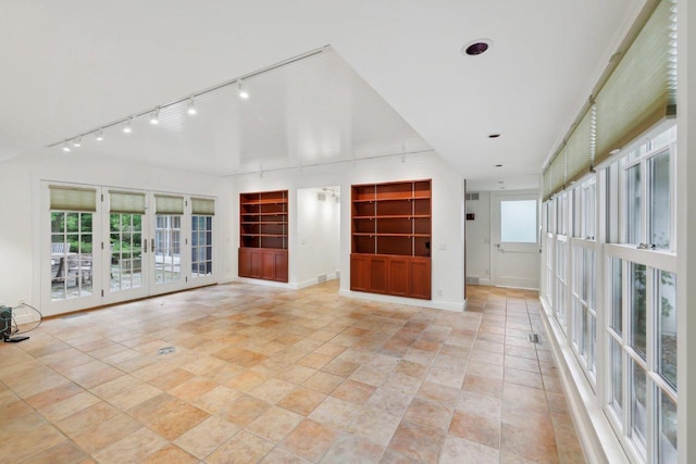 923 Swarthmore Ct, Madison, WI 53705 - unfurnished living room with built in features, track lighting, baseboards, and french doors