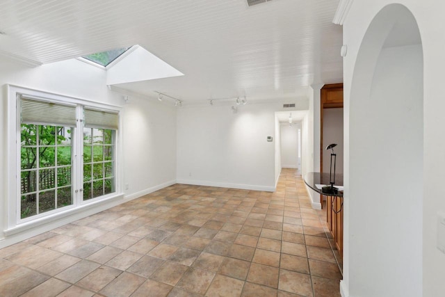 923 Swarthmore Ct, Madison, WI 53705 - unfurnished room with track lighting, a skylight, baseboards, and light stone finish floors