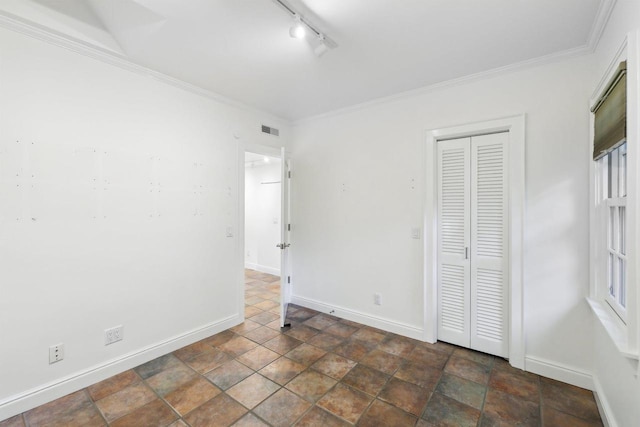 923 Swarthmore Ct, Madison, WI 53705 - unfurnished bedroom with baseboards, rail lighting, ornamental molding, and a closet