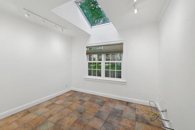 923 Swarthmore Ct, Madison, WI 53705 - spare room featuring track lighting, a skylight, baseboards, crown molding, and stone finish flooring