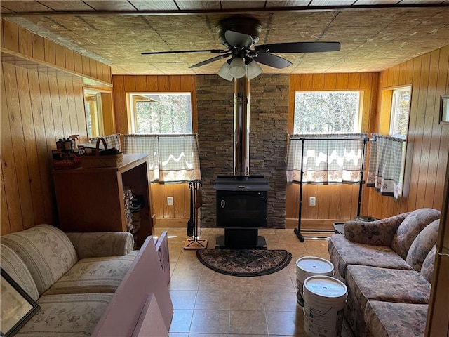 15735 N Park Rd, Butternut, WI 54514 - living area with plenty of natural light, wood walls, a ceiling fan, and a wood stove