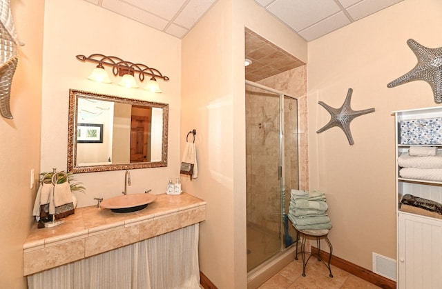 7601 S Cambridge Dr, Franklin, WI 53132 - full bathroom with a paneled ceiling, a stall shower, vanity, and baseboards
