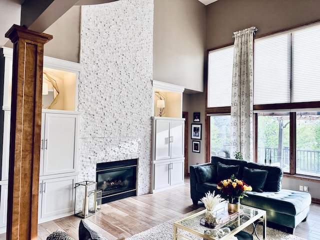 7601 S Cambridge Dr, Franklin, WI 53132 - living area featuring a towering ceiling, light wood-type flooring, and a fireplace