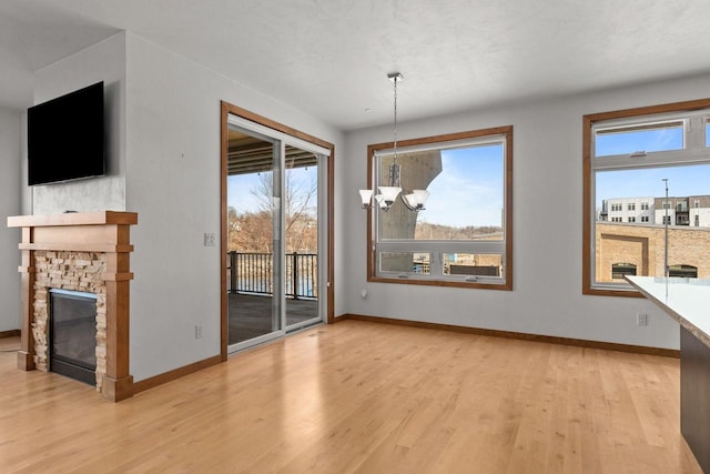1141 E Banta Ct, Appleton, WI 54914 - unfurnished dining area with baseboards, a chandelier, light wood finished floors, and healthy amount of natural light