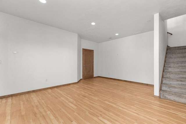 1141 E Banta Ct, Appleton, WI 54914 - unfurnished living room featuring light wood finished floors, recessed lighting, stairway, and baseboards