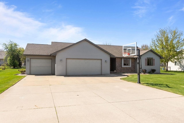 view of front of home with a garage, driveway, a front yard, and roof with shingles