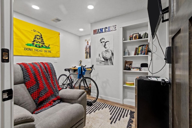 living area with wood finished floors, baseboards, and recessed lighting